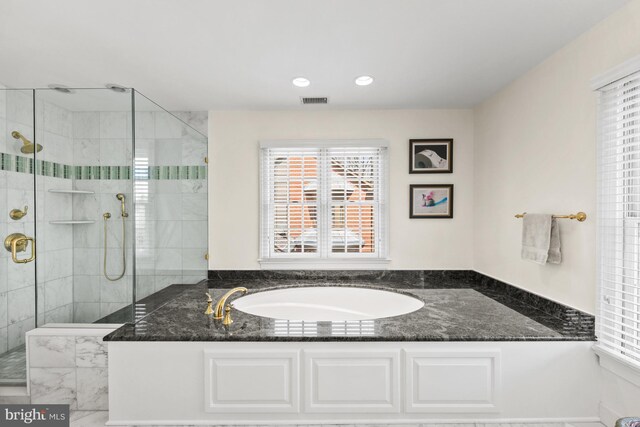 full bath with a shower stall, a bath, and recessed lighting