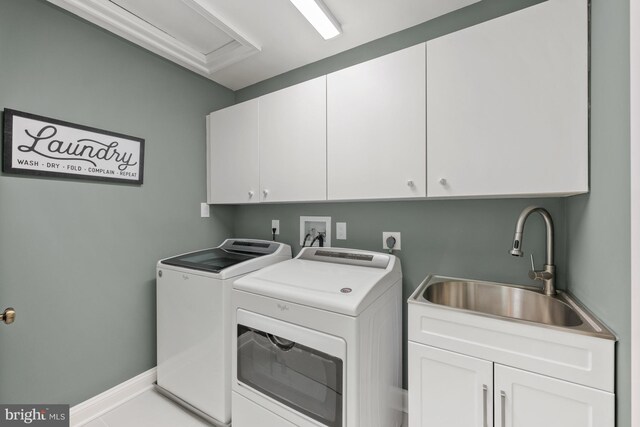 laundry area with cabinet space, washing machine and dryer, and baseboards