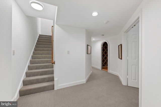 stairway with carpet, recessed lighting, and baseboards