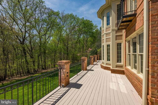 wooden terrace with a yard