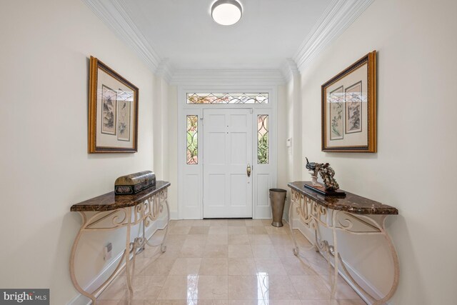 foyer with crown molding and baseboards