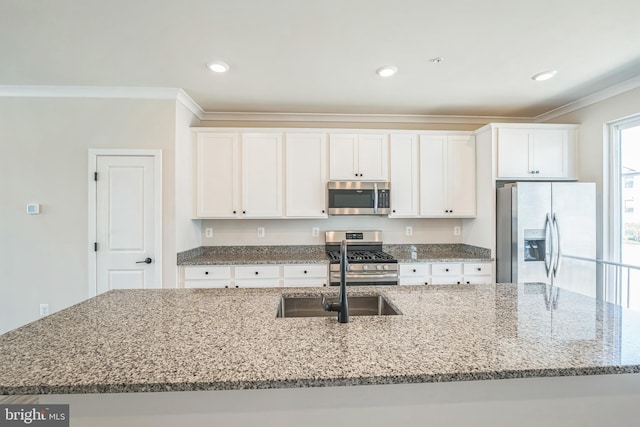 kitchen featuring ornamental molding, a kitchen island with sink, light stone countertops, white cabinetry, and stainless steel appliances