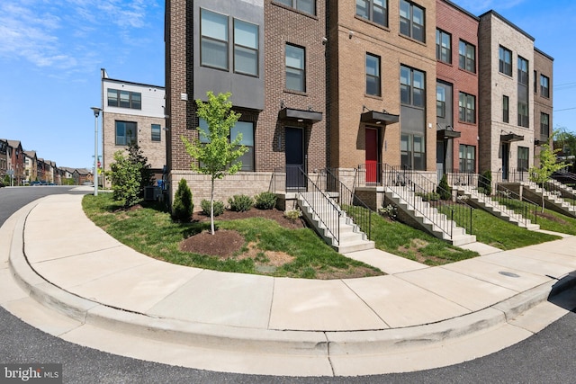 view of front of home featuring brick siding and a residential view