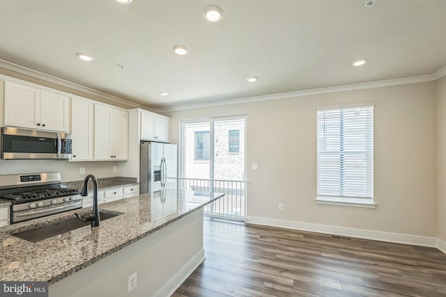 kitchen with crown molding, stainless steel appliances, dark wood-style flooring, and a sink
