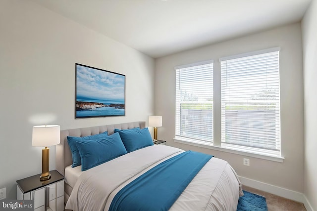 bedroom with baseboards and carpet