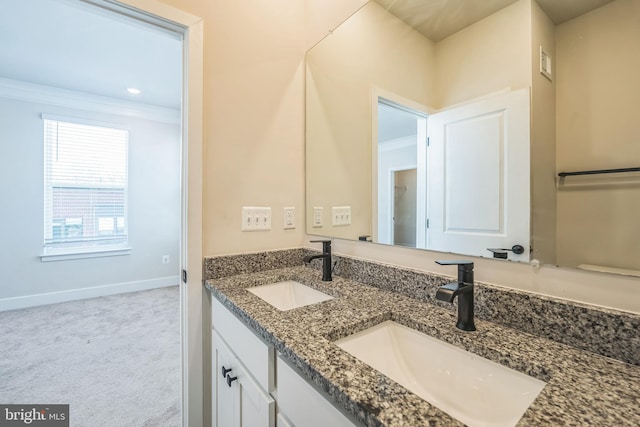 full bath with a sink, crown molding, double vanity, and visible vents