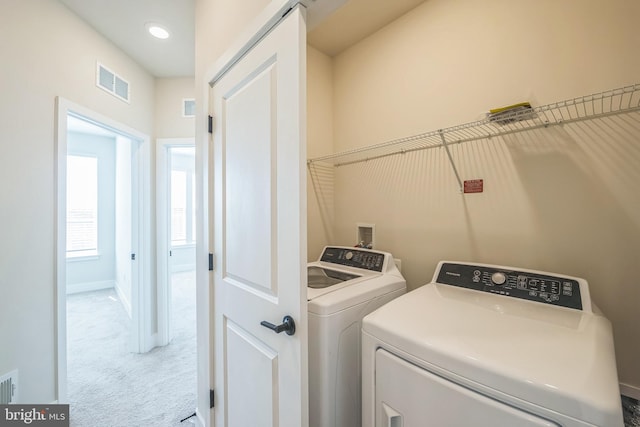 laundry room featuring washer and dryer, laundry area, carpet floors, and visible vents