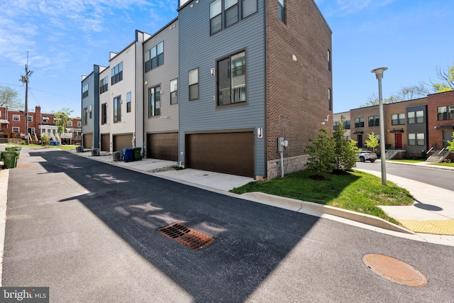 exterior space featuring an attached garage and a residential view