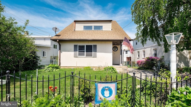 bungalow-style home with fence, a shingled roof, and a front lawn