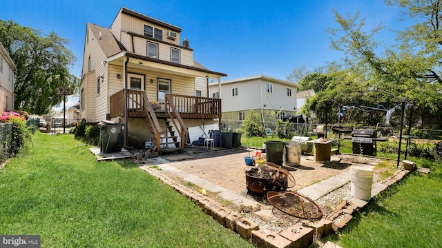 back of property featuring stairs, an outdoor fire pit, a fenced backyard, a lawn, and covered porch