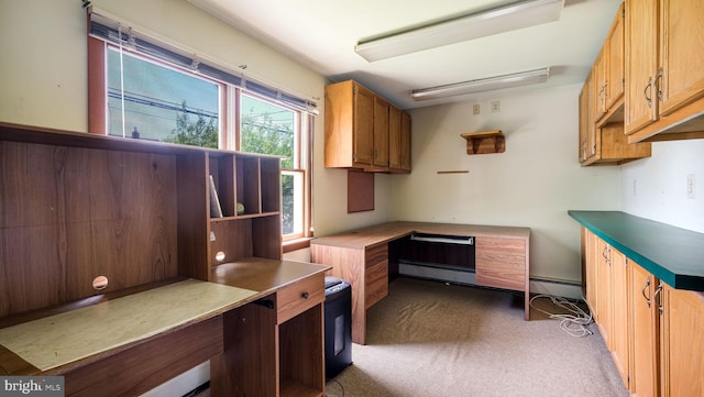 office space with a baseboard radiator and dark colored carpet