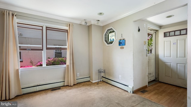 spare room with visible vents, a healthy amount of sunlight, and baseboard heating