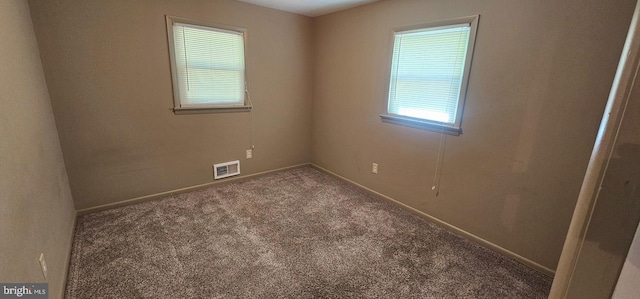 spare room with baseboards, visible vents, and carpet floors