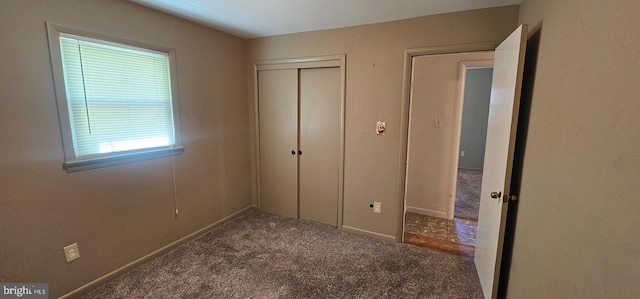 unfurnished bedroom with a closet and carpet floors
