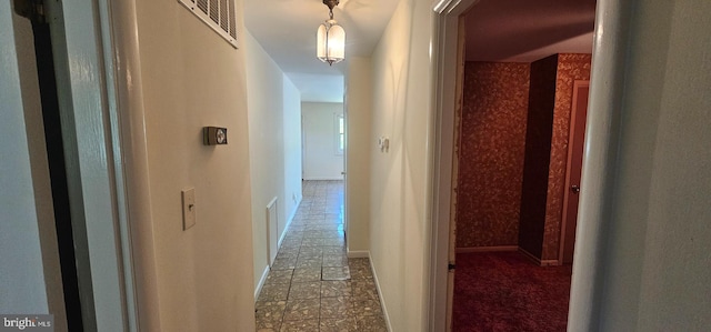 hall featuring visible vents and tile patterned flooring