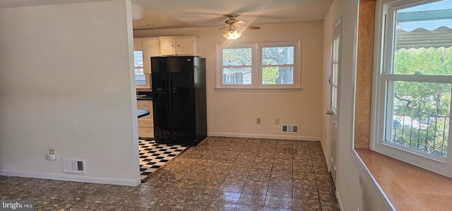 kitchen with visible vents, black refrigerator with ice dispenser, and a healthy amount of sunlight