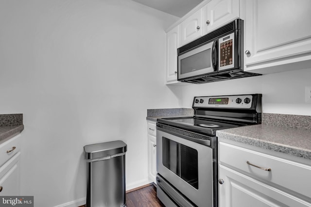 6703 Rapid Water Way Unit 203, Glen Burnie, MD 21060 - kitchen with baseboards, electric stove, white cabinets, and dark wood-style floors