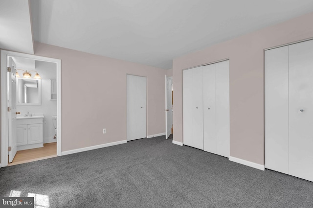 6703 Rapid Water Way Unit 203, Glen Burnie, MD 21060 - unfurnished bedroom featuring carpet floors, two closets, baseboards, a sink, and ensuite bath