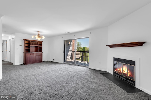 6703 Rapid Water Way Unit 203, Glen Burnie, MD 21060 - unfurnished living room with baseboards, a fireplace with flush hearth, carpet floors, and a chandelier