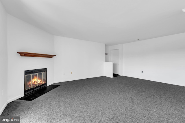 6703 Rapid Water Way Unit 203, Glen Burnie, MD 21060 - unfurnished living room featuring baseboards, a fireplace with flush hearth, and carpet