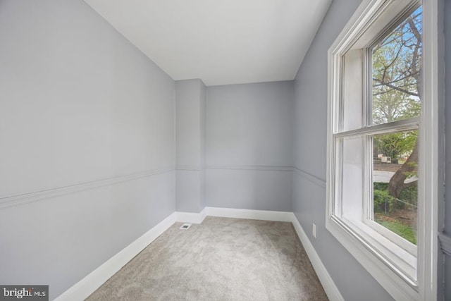 spare room with carpet floors and baseboards
