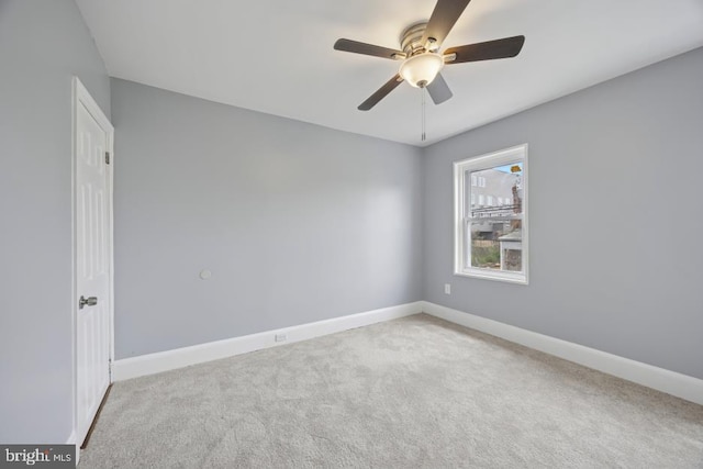 unfurnished room with carpet floors, baseboards, and ceiling fan