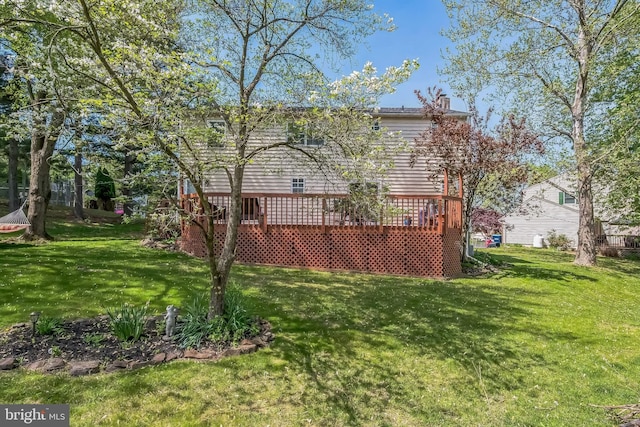 10 Shawnee Ln, Royersford, PA 19468 - rear view of property featuring a wooden deck, a lawn, and a chimney