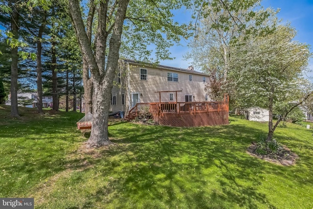 10 Shawnee Ln, Royersford, PA 19468 - rear view of property with a deck, a yard, and a chimney