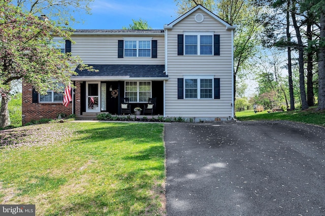 10 Shawnee Ln, Royersford, PA 19468 - traditional-style house with covered porch, a front lawn, and brick siding