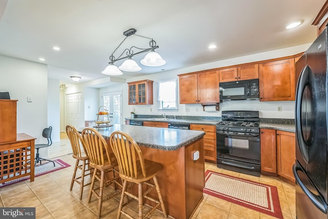 10 Shawnee Ln, Royersford, PA 19468 - kitchen featuring black appliances, a sink, light tile patterned flooring, a kitchen bar, and a kitchen island