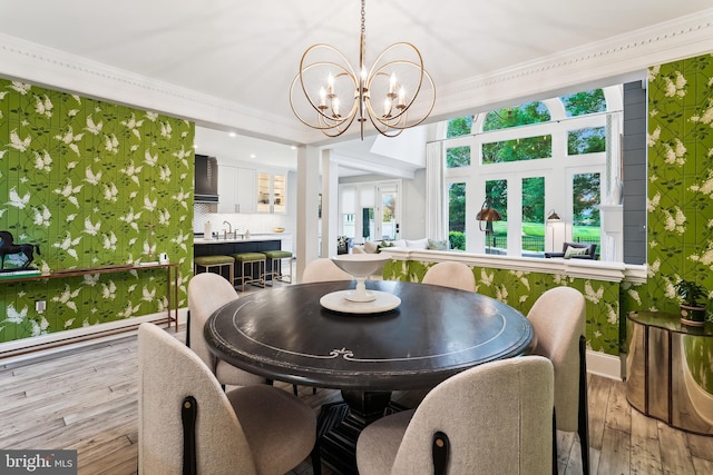 sunroom / solarium featuring a chandelier and a sink