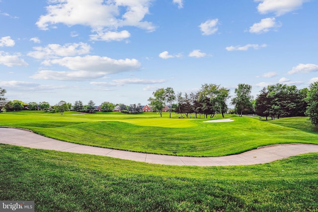 surrounding community featuring a yard and golf course view