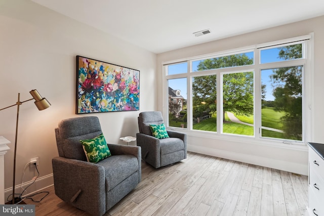 sitting room featuring light wood-type flooring and baseboards