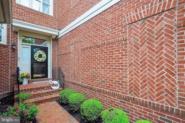property entrance featuring brick siding