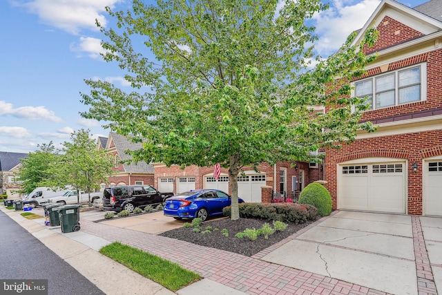 view of front of property featuring driveway and brick siding