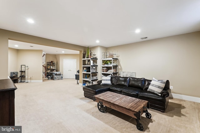 carpeted living area featuring recessed lighting and baseboards