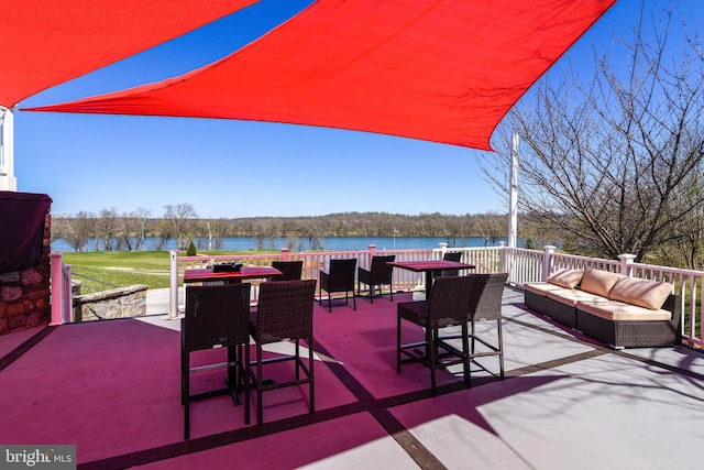 view of patio featuring an outdoor living space and a water view