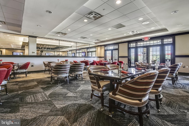 carpeted dining space with a paneled ceiling, baseboards, and recessed lighting