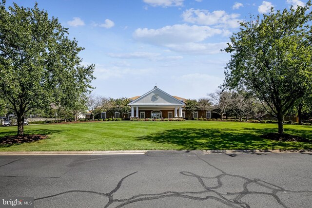 neoclassical home with a front yard