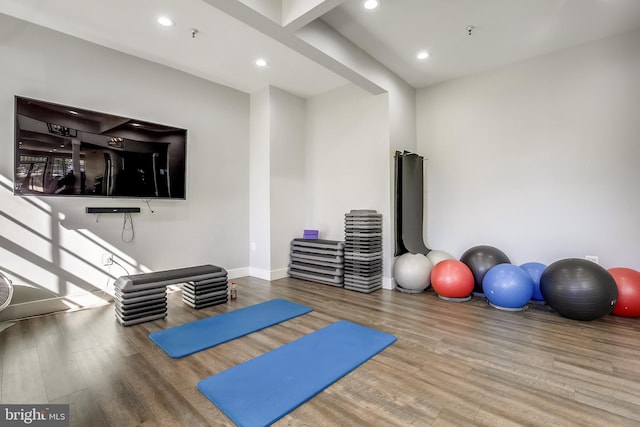 workout room with wood finished floors, recessed lighting, and baseboards