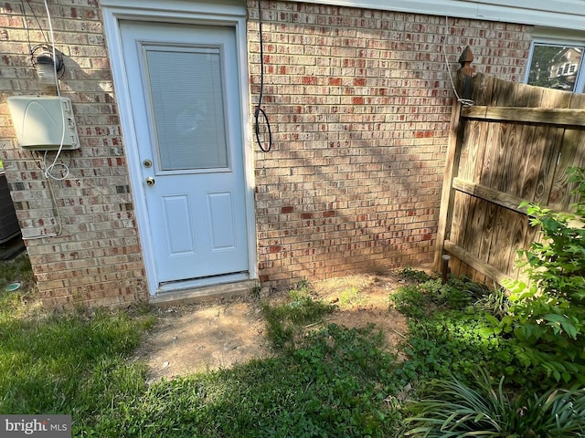 property entrance with brick siding