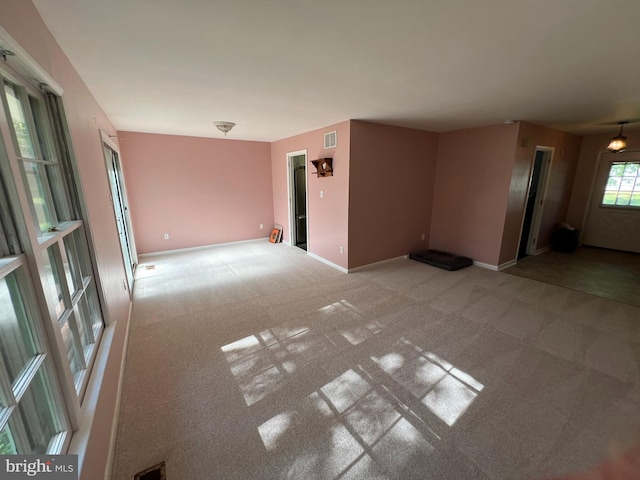carpeted spare room with baseboards and visible vents