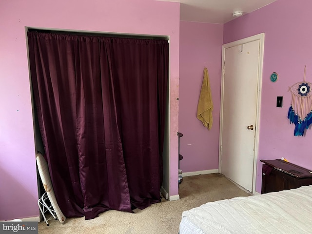 carpeted bedroom featuring baseboards