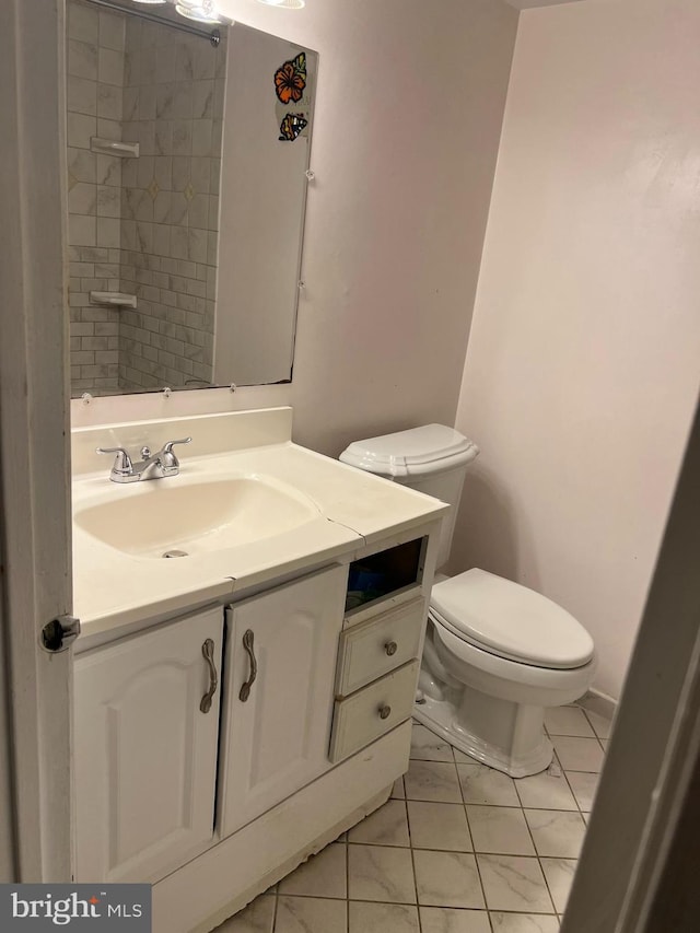 full bathroom with vanity, toilet, a shower, and marble finish floor