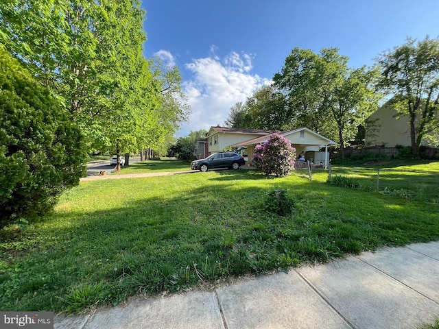 exterior space featuring a lawn and fence