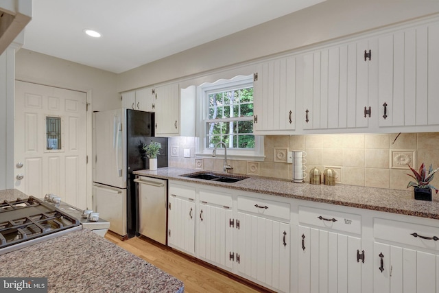 4303 S Valiant Ct, Annandale, VA 22003 - kitchen featuring a sink, dishwasher, white cabinets, decorative backsplash, and freestanding refrigerator