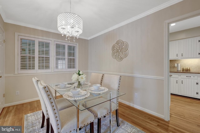 4303 S Valiant Ct, Annandale, VA 22003 - dining room with light wood finished floors, a chandelier, ornamental molding, and baseboards