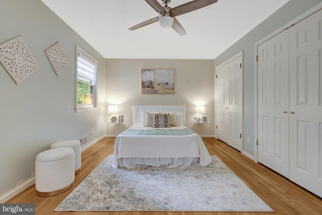 4303 S Valiant Ct, Annandale, VA 22003 - bedroom with two closets, light wood-type flooring, baseboards, ornamental molding, and a ceiling fan