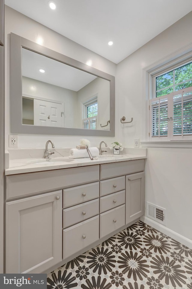 4303 S Valiant Ct, Annandale, VA 22003 - bathroom featuring healthy amount of natural light, double vanity, baseboards, and recessed lighting