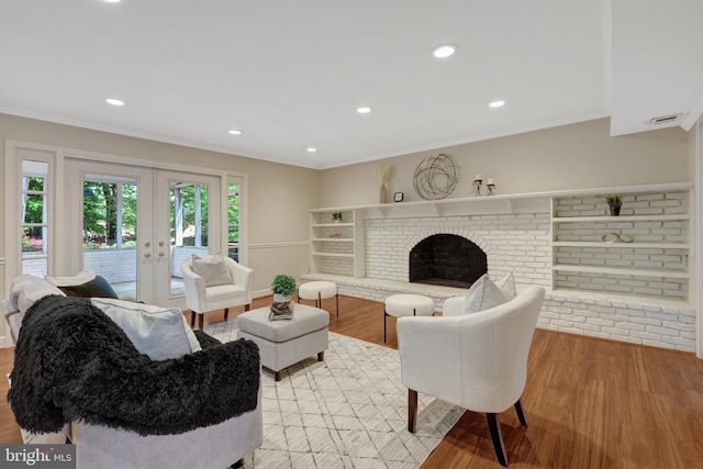 4303 S Valiant Ct, Annandale, VA 22003 - living room with light wood finished floors, french doors, a fireplace, and recessed lighting